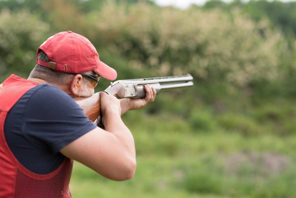 Man shooting skeet with a double gun.