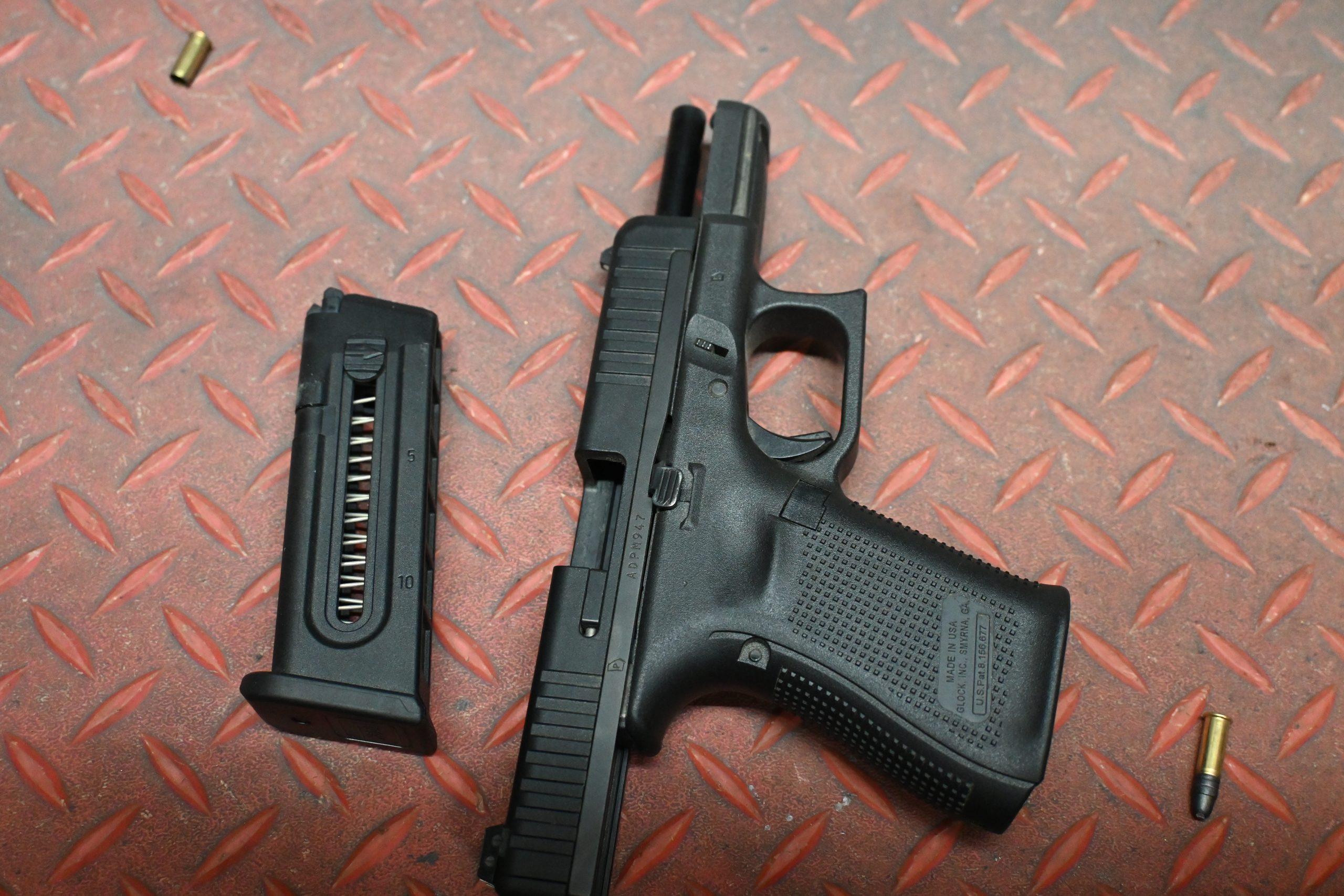Glock 44 with slide locked back, hybrid polymer and steel slide visible