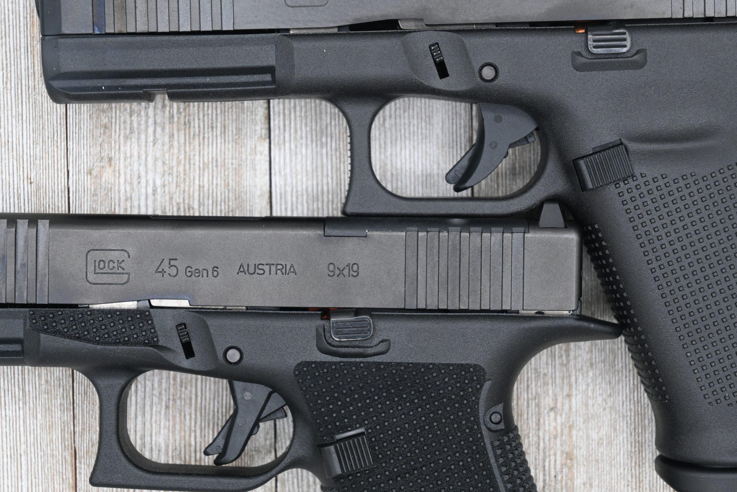 The Gen 6's flat face trigger (bottom) versus the traditional curved shoe of the Gen 5 (top). The blade safety recesses more fully into the flat shoe, and the geometry produces a slightly shorter trigger reach and a cleaner perceived break.